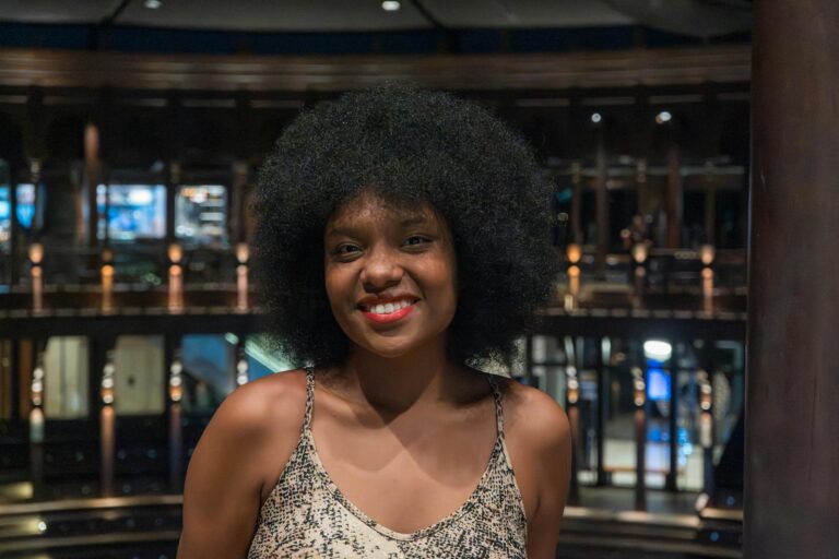 smiling woman with natural afro hair indoors