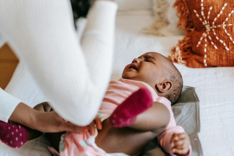 mother soothing cute crying little black daughter