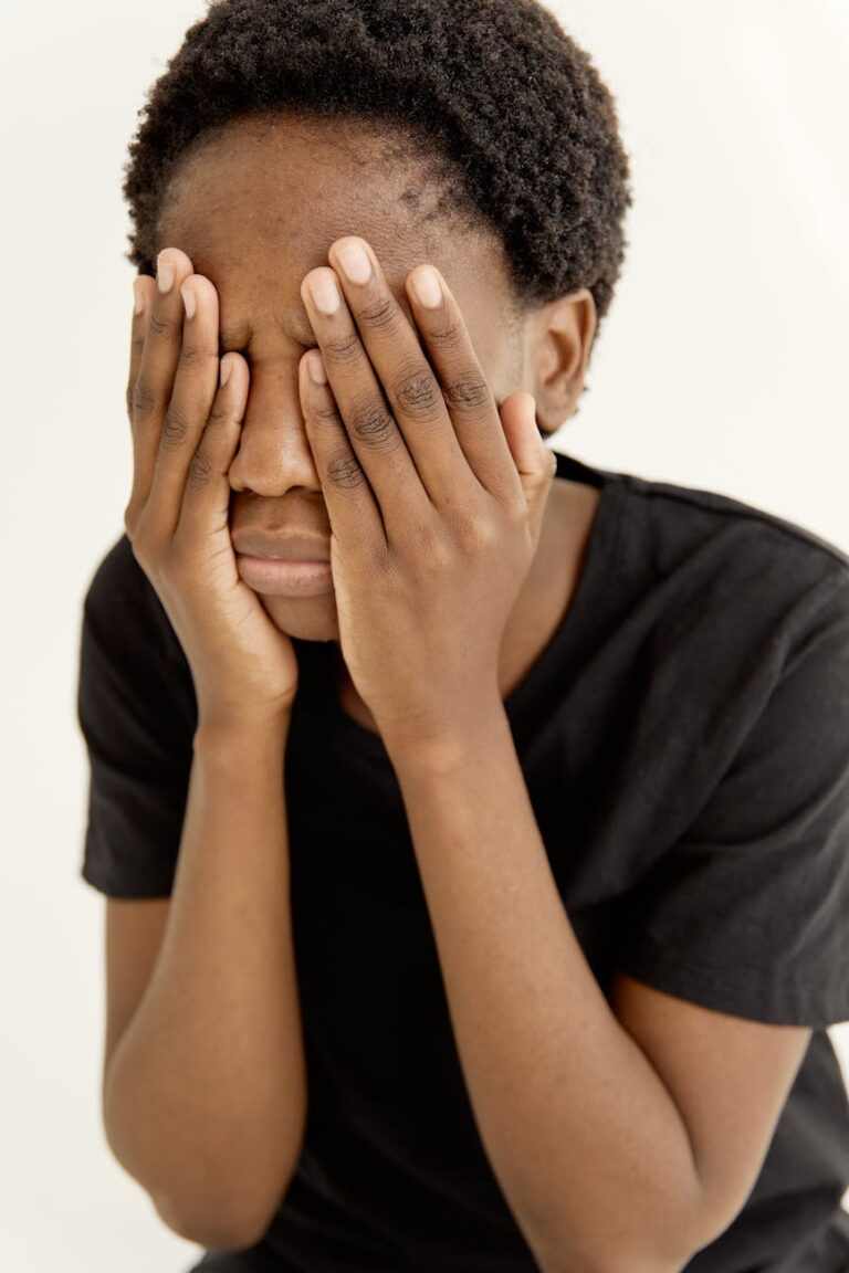 a woman covering her face