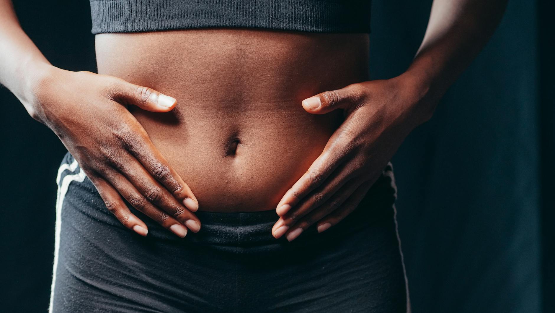 a person touching her belly
